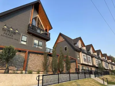 a building with a sign on the side of it at New 3BR with Mountain Views Near DT Hot Tub and Pool in Canmore