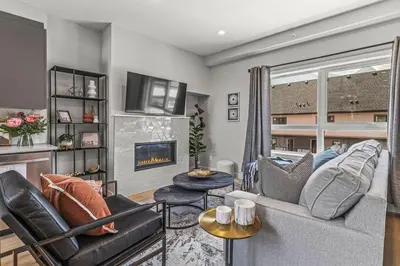 a living room with a couch and a fireplace at New 3BR with Mountain Views Near DT Hot Tub and Pool in Canmore