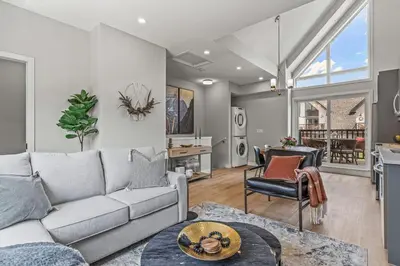 a living room with a couch and a table at New 3BR with Mountain Views Near DT Hot Tub and Pool in Canmore