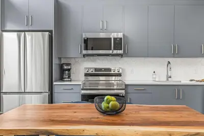 a kitchen with a bowl of fruit on a wooden table at 3BR with Stunning Views Self Check-In and Free Parking in Canmore