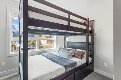a bedroom with a bunk bed and a window at 3BR with Stunning Views Self Check-In and Free Parking in Canmore