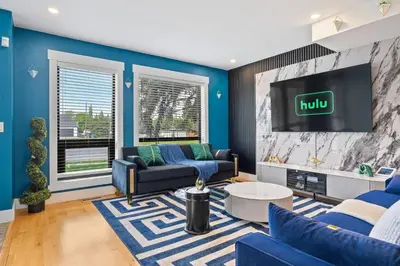 a living room with a couch and a tv at *Spectacular* Sauna |Rocket-ship|Game-Room|Hammock in Calgary
