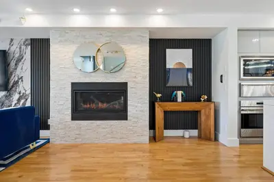 a living room with a fireplace and a table at *Spectacular* Sauna |Rocket-ship|Game-Room|Hammock in Calgary