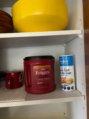 a refrigerator shelf with a jar of food and a can of chicken broth at Luxurious & Spacious 4-Bedroom Vacation Home in Edmonton