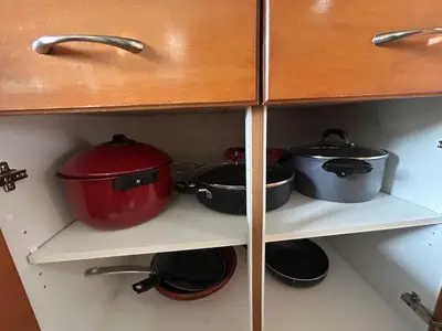 a shelf with pots and pans in a kitchen at Luxurious & Spacious 4-Bedroom Vacation Home in Edmonton