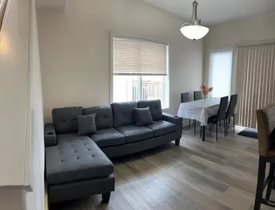 a living room with a couch and a table at Luxurious & Spacious 4-Bedroom Vacation Home in Edmonton