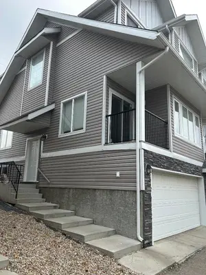 a gray house with stairs and a garage at Luxurious & Spacious 4-Bedroom Vacation Home in Edmonton