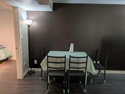 a table with chairs and a vase on top of it at 2-Room Suite in South Edmonton in Edmonton