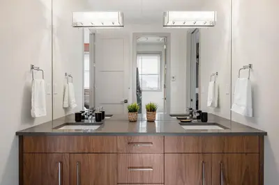 a bathroom with two sinks and a large mirror at *Incredible Location* |Two King Beds| Free Parking in Calgary