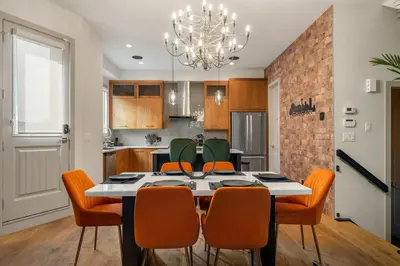 a kitchen and dining room with a table and chairs at THE Getaway For BIG Groups-DT in Calgary