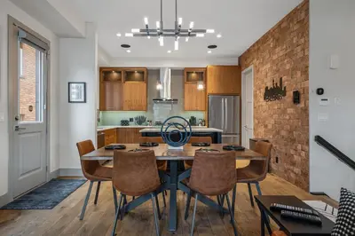 a kitchen and dining room with a table and chairs at THE Getaway For BIG Groups-DT in Calgary