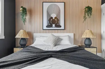a bedroom with a large bed with two lamps at *Everything*| Hot Tub| Sauna| Pool table|Game Room in Calgary