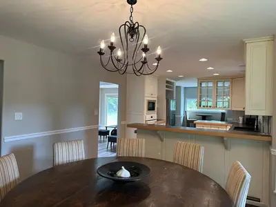 a dining room and kitchen with a table and chairs at Charming 4-Bedroom Home in Bella Coola in Hagensborg