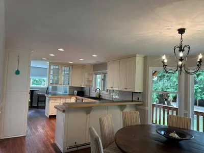 a kitchen with a table and a dining room at Charming 4-Bedroom Home in Bella Coola in Hagensborg