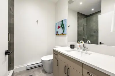 a bathroom with a sink and a toilet at Brand-New Luxury Dunbar 4BR Home - Near UBC - Sleep 10 - Ideal for Family in Vancouver