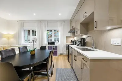 a kitchen and dining room with a table and chairs at Brand-New Luxury Dunbar 4BR Home - Near UBC - Sleep 10 - Ideal for Family in Vancouver