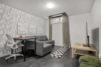 a living room with a couch and a table at Modern Suburban Retreat in Ambleton Stylish Comfort Near Parks and Trails in Calgary