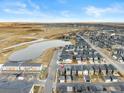an aerial view of a city with buildings and a body of water at Modern Suburban Retreat in Ambleton Stylish Comfort Near Parks and Trails in Calgary