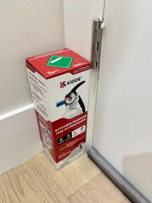 a box sitting on the floor next to a refrigerator at Excellent Place to Stay in Coquitlam