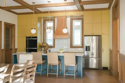 a kitchen with a table and chairs and a refrigerator at Samson House in Revelstoke