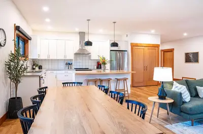 a kitchen and living room with a table and chairs at Cartier Chalet in Revelstoke