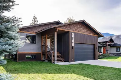 a house with a garage in a yard at Cartier Chalet in Revelstoke