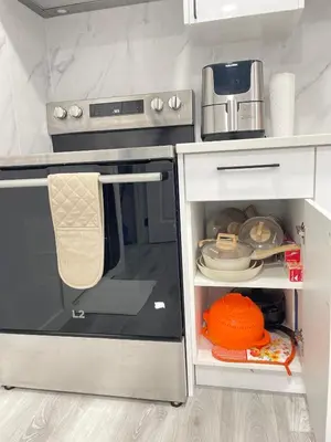 a kitchen with an oven with its door open at Ivey Homes in Edmonton