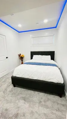 a bedroom with a bed with a blue ceiling at Ivey Homes in Edmonton