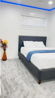 a bedroom with a bed with a blue ceiling at Ivey Homes in Edmonton