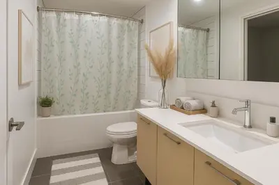 a bathroom with a sink toilet and a shower curtain at Urban Two-Bedroom Apartment with Prime Downtown Location in Vancouver