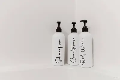three white bottles withigraphy on them on a white background at Lynn Valley 2BR Suite By Grouse Mtn & Lynn Canyon in North Vancouver