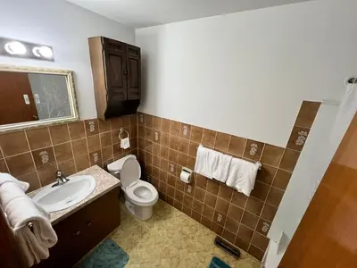 a bathroom with a toilet and a sink at mysev property in Calgary