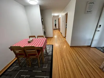 a dining room with a table and chairs and a hallway at mysev property in Calgary