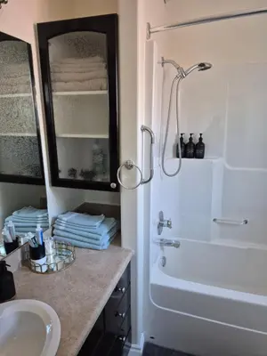 a bathroom with a tub and a sink and a shower at Northern Solace, 2 beds, 2 baths, 5 min to airport in Yellowknife