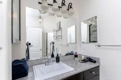 a bathroom with a sink and a large mirror at Northern Solace, 2 beds, 2 baths, 5 min to airport in Yellowknife