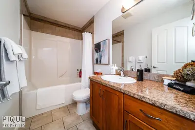 a bathroom with a sink and a toilet and a shower at 6BDRM Chic Modern Home-Fireplace-BBQ-Sleeps 18! in Edmonton