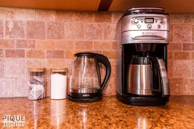 a coffee maker sitting on top of a counter at 6BDRM Chic Modern Home-Fireplace-BBQ-Sleeps 18! in Edmonton