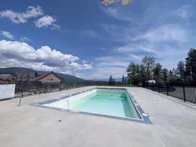 a swimming pool in the middle of a yard at Rocky Mountain Condos by StayIn in Kimberley