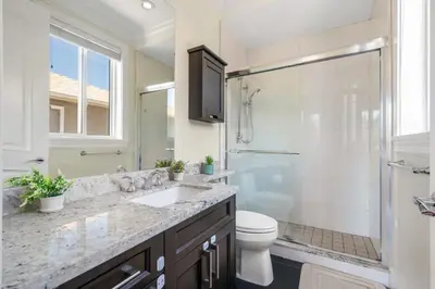 a bathroom with a sink and a shower and a toilet at Luxury 4-Bedroom Villa in Vancouver