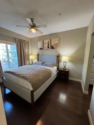 a bedroom with a bed and a ceiling fan at Peaceful Condo for Short and Long Term Rental in Edmonton