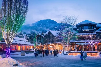 a group of people walking around a town with christmas lights at 1BR and Sofabed in The Gables, Epic Village Location, Secure Parking, Forest Views in Whistler