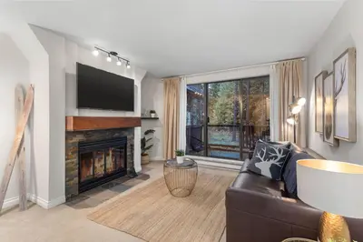a living room with a couch and a fireplace at 1BR and Sofabed in The Gables, Epic Village Location, Secure Parking, Forest Views in Whistler