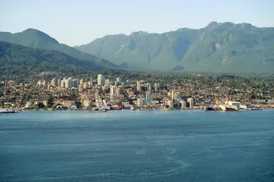 a city on the shore of a large body of water at Modern 2Bed Suite Near Capilano Bridge & Trails in North Vancouver