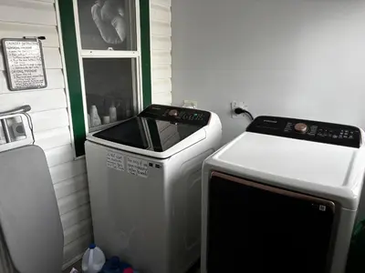 a small refrigerator and a stove in a room at Character Home near Downtown and 17th Avenue in Calgary