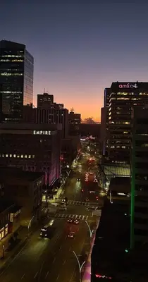 a city street at night with cars on the road at Apartment in Downtown YEG in Edmonton