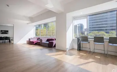 a living room with a couch and chairs and windows at Apartment in Downtown YEG in Edmonton