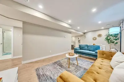 a living room with a couch and a table at Spacious 3 BDR Suite Sleeps 6 Comfortably in Edmonton
