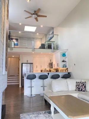 a living room with a couch and a kitchen at Tanglewood 13 in Parksville