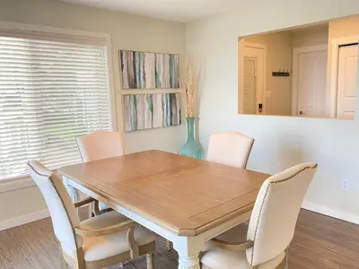 a dining room with a wooden table and chairs at Tanglewood 13 in Parksville