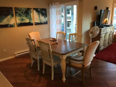 a dining room with a wooden table and chairs at Tanglewood 18 in Parksville